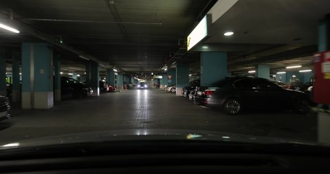 BUDAPEST, HUNGARY - JULY 19, 2019: Driving in the parking lot in the basement of a shopping mall, driver's point of view