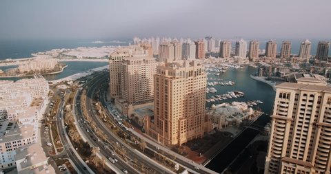 Time lapse of a modern, living city full of skyscrapers. High rise downtown in Doha, Qatar. Busy strees seen from above. Urban landscape on a timelapse.