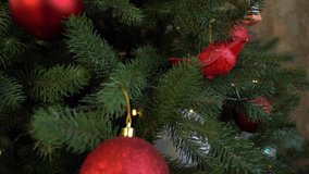 Abstract holiday xmas background. Closeup view 4k video footage of decorated with red and gold shiny balls Christmas pine tree