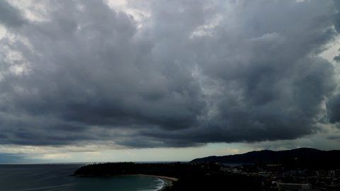 Rainstorm over the Asia pacific ocean in Phuket, Thailand. Bad weather with clouded sky, rain. Massed gray clouds flowing over, climate change, tropical storm with bolt. Tornado, twister. Time-lapse.
