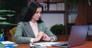 Business woman talking on video communication using laptop. Online training or distance work. Having conversation, gesticulates and looking at laptop screen. Medium shot
