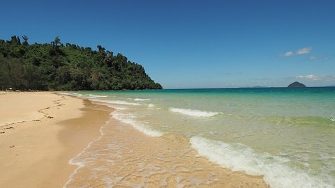 Beautiful footage of khokangkao beach with blue skies, white clouds and emerald sea in Ranong province.