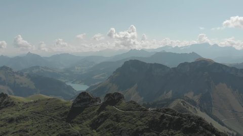 
Aerial shot of Alps mountains. Mountains, peaks, cliffs, rocks, ridges, landscape, green grass, sky, clouds, nature, uncultivated nature, drone video.