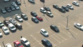 Aerial top view from drone of parking lot cars of the business center, shopping mall, supermarket or hospital with cars and empty parking spots at day. Transport. City. Urban.4k footage