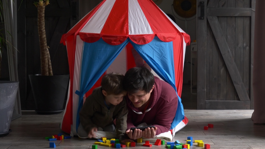 Father and son watching cartoons in a small children