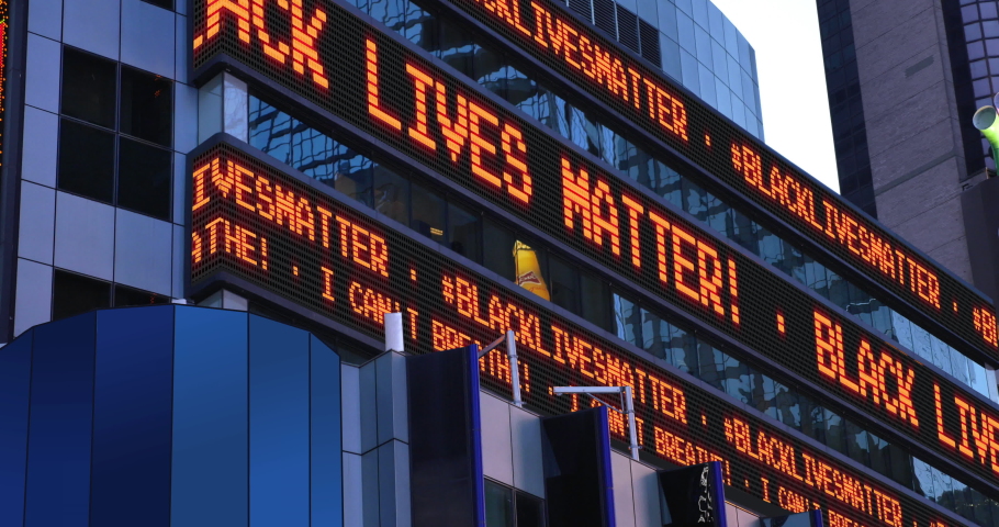 A Times Square stock market ticker displays the "Black Lives Matter" and "I Can't Breathe" statements. These phrases were commonly heard in protests after the killing of George Floyd by police in MN. Royalty-Free Stock Footage #1053568592