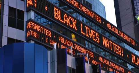 A Times Square stock market ticker displays the "Black Lives Matter" and "I Can't Breathe" statements. These phrases were commonly heard in protests after the killing of George Floyd by police in MN.