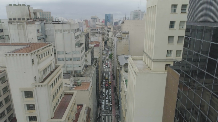 Aerial View through buildings of the city downtown in sao paulo brazil. Busy street fincancial center
