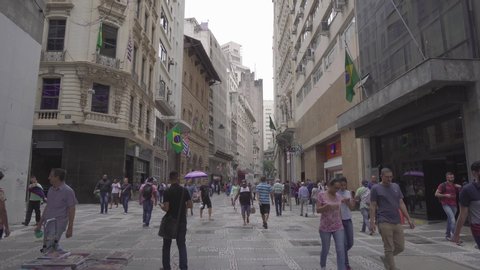 A street in Sao Paulo people walk, Camera moves. 4k video. Sao- Paolo, Brasil, March 10, 2018. 