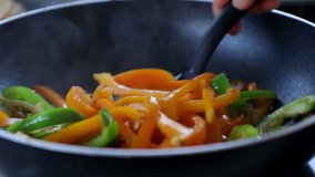 Cooking vegetables in the frying pan close-up paleo vegan diet