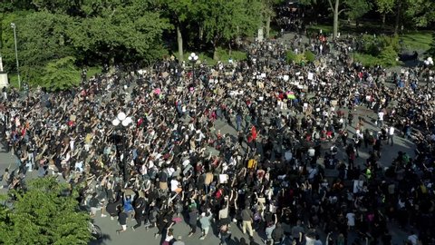 NEW YORK - JUNE 1, 2020: aerial flyover drone flying over crowd of protestors with signs after killing of George Floyd, demonstrators in Washington Square Park, NYC.