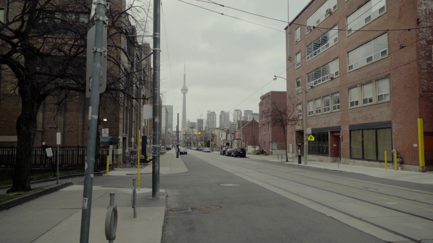 Toronto, Canada in lockdown. A eerily deserted, empty downtown street during the covid-19 Coronavirus pandemic. Cold and grey day. Royalty-Free Stock Footage #1053577430