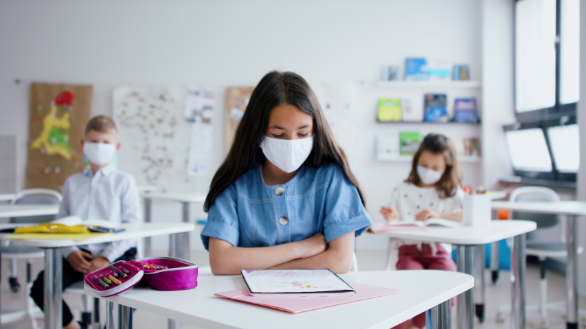 Child with face mask back at school after covid-19 quarantine and lockdown. | Shutterstock HD Video #1053578888