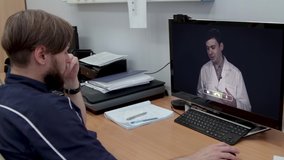 Doctor at his workplace uses video conferencing to communication with colleague discussing coronovirus patients.Online healthcare digital technology service.Telemedicine.
