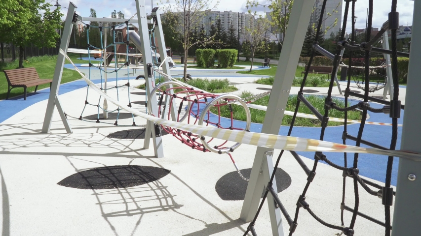 Playground closed with quarantine tapes in the city park of Southern Butovo