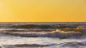 Sea sunrise. Ocean waves splashing on the beach
