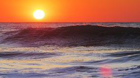 Golden sunrise over the sea waves