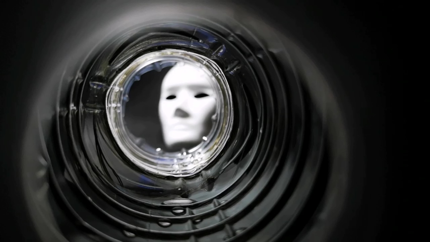 White mask after the light in a clear glass hole