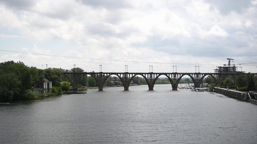 River, flows in the city of Dnieper, Ukraine. A railway arch bridge is visible in the background.
