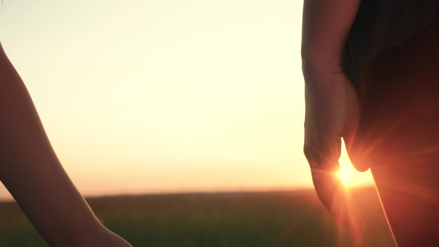 happy family mom and son hold hands close-up teamwork. mother and boy kid together hands at sunset. parent girl and child happy childhood. happy family mother day concept lifestyle Royalty-Free Stock Footage #1053602276