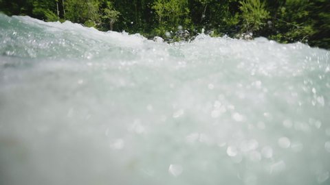 Super slow motion underwater river flow, clean pure water pouring over the stone, rapid in emerald river Soca, Slovenia