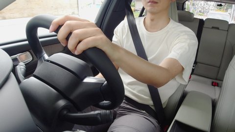 Young man driving a car. Vehicle interior.