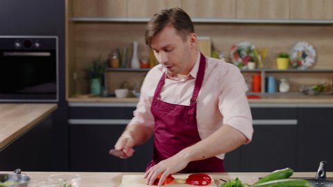 Cooking show host celebrity chef shows hot to cut pepper, broadcast TV programme. Shot on ARRI Alexa Mini