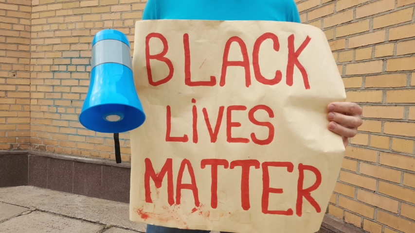 closeup male hands holding a poster black lives matter,  in united states