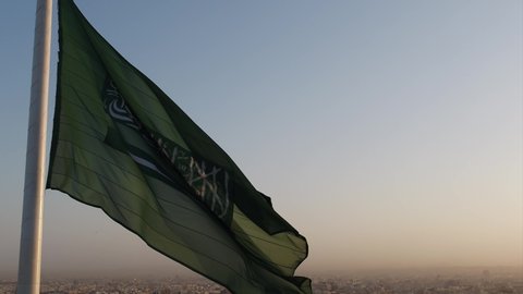 Drone shot of the Saudi Arabia flag at the roundabout during the evening