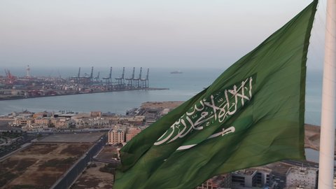 Beautiful drone shot of the Saudi Arabian flag hoisted at the famous roundabout