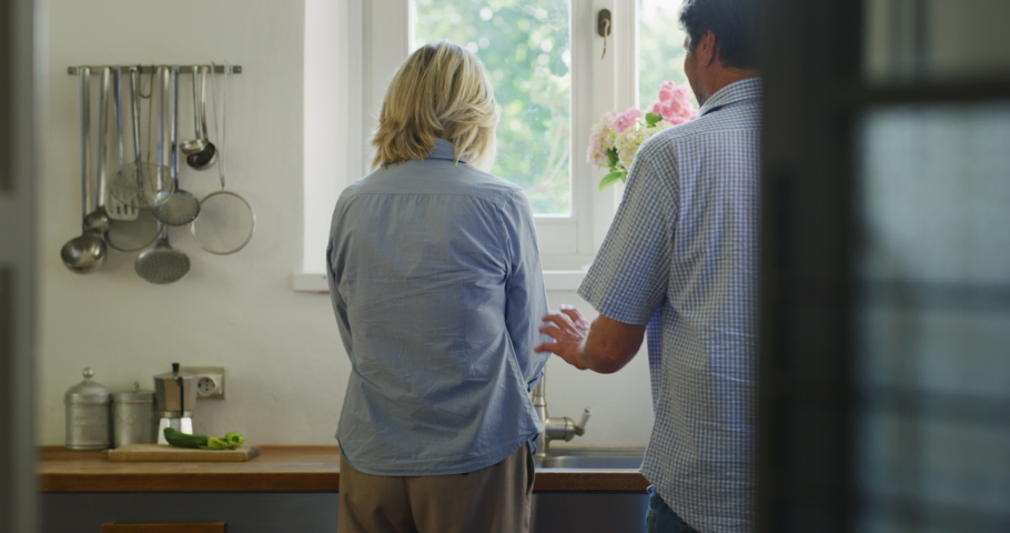 Authentic shot of lovely happy mature couple is having fun dancing to celebrate their timeless love in a kitchen at home. Concept: love, family, marriage, happiness, home, food