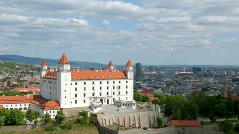 Aerial of Bratislava Castle, Slovakia - Cinematic Establishing Crane Shot of a Medieval Fairytale Bratislava Castle With Ancient Walls and Bratislava Cityscape, During a Quiet Sunny Day