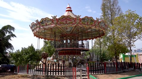 The carousel on the amusement park one sunny day