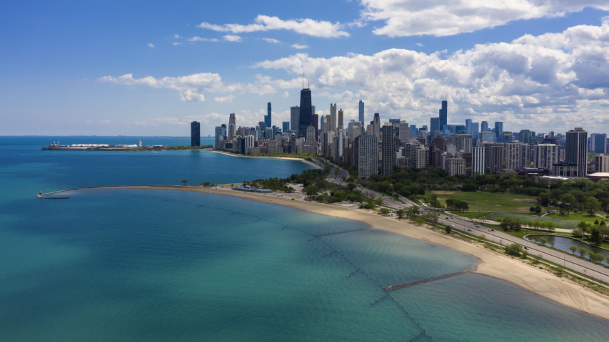 Chicago city skyline and road with cars leading to big city, Aerial Hyperlapse with fast moving clouds | Shutterstock HD Video #1053639596