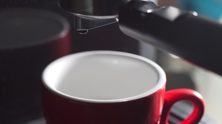 Footage B Roll of Pouring coffee stream from machine in cup. Home making hot Espresso. Using filter holder. Flowing fresh ground coffee. Drinking roasted black coffee in the morning.  | Shutterstock HD Video #1053640061