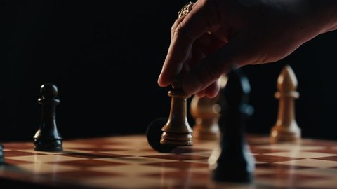 Chess checkmate on wooden chessboard pawn and queen man hand close up video