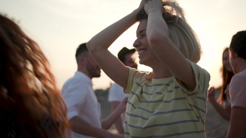 Happy Laughter Joyful 30s Female Listen Music and Dance in Summer Sunshine. Multi Ethnic Group Young Girls and Guys Arms Raised Enjoy Nature Outdoor. Happiness Life People Energy 4k Slow Motion Shot