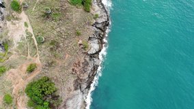 Drone video, Beautiful tropical beach top view. Phuket thailand, beach paradise Aerial drone shot of turquoise sea water, with rock stone. Palm trees on the beach. Promtaep Cape Holiday  Vacation.