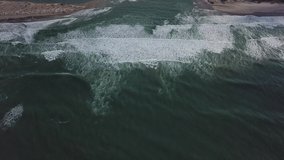 Stunning slow motion aerial footage of waves breaking.