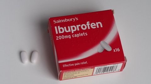 Sainsbury's Ibuprofen box of 200mg caplets at home. 3rd June, 2020. Supplies low in most UK supermarkets, stockpiling due to Coronavirus outbreak. Static shot with two pills.