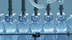 Automatic conveyor line for bottling mineral water in the plastic bottle. Line for PET bottle water. Water factory-bottling pure spring water into bottles. Selective focus. - Powered by Shutterstock - Get 15% off with code: PIKWIZARD15