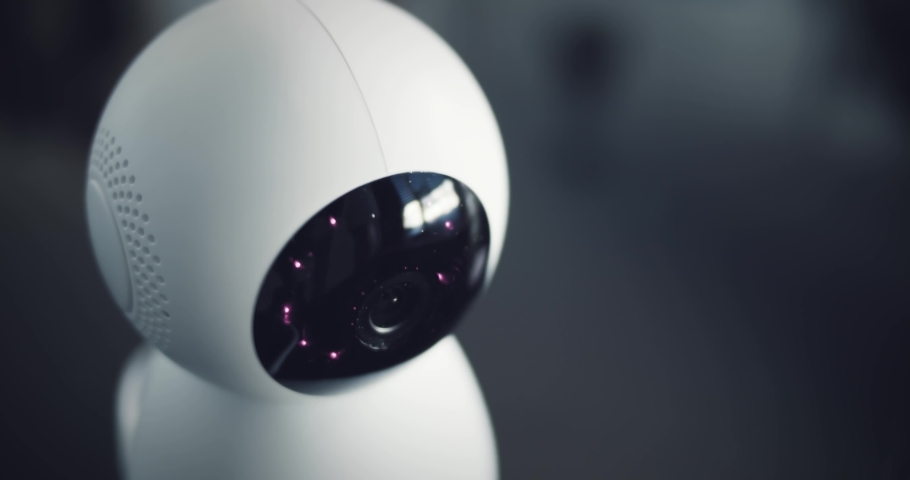 Robot home security camera looks around the area. Security futuristic camera scans the surroundings. Digital HUD overlay. | Shutterstock HD Video #1053665804