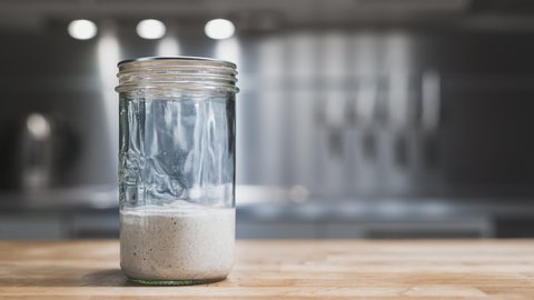 Flour And Water Mixture Rising In A Glass Jar During Fermentation Process For Sourdough Starter - Timelapse