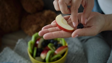 Video of mother convincing her baby son to eat some fruit. Shot with RED helium camera in 8K