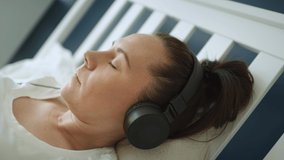 Zoom out video of woman pregnant listening to music. Shot with RED helium camera in 8K - Powered by Shutterstock - Get 15% off with code: PIKWIZARD15