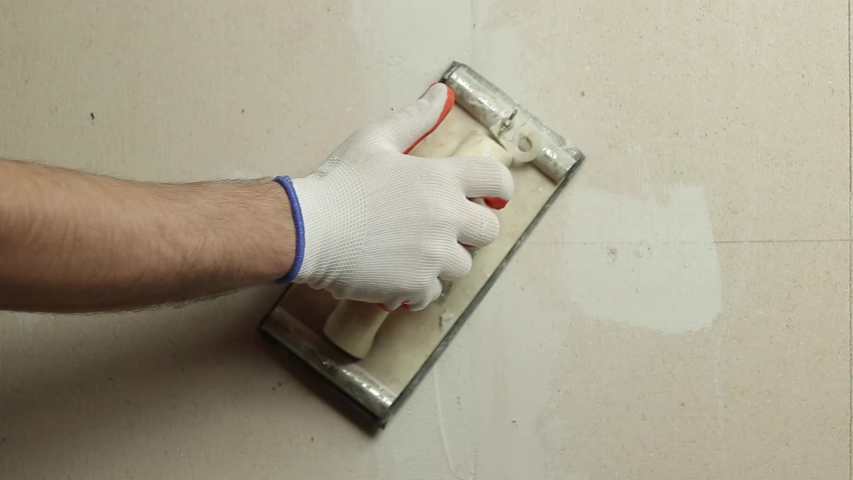 Sanding the walls before priming and painting. sanding the walls of the putty.
 | Shutterstock HD Video #1053672116