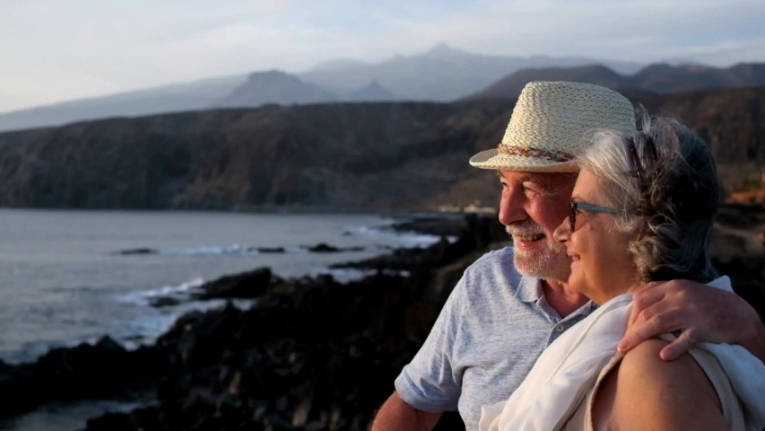 Two happy active seniors together having fun
at the beach in evening afternoon in sea town - couple of mature people enjoying and having fun in vacations - traveling and travelers lifestyle | Shutterstock HD Video #1053674261