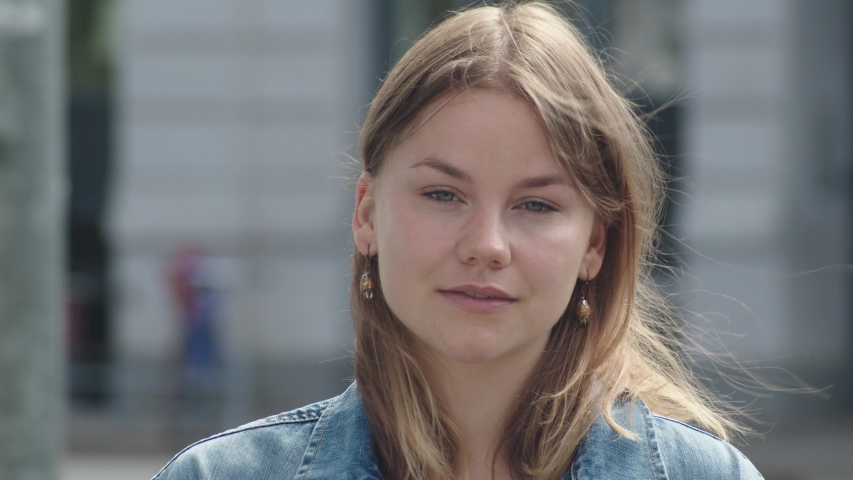 Portrait of a Happy Teenage Girl Wearing Sunglasses in City.