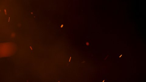 4k fire embers and fire sparks over black background,fire flames and particles swirls in the air, ready to use in your compositions