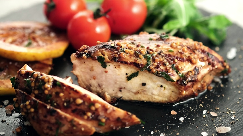 Chef cuts the knife juicy grilled chicken breast covered with honey and mustard sauce. Healthy eating. Royalty-Free Stock Footage #1053691109